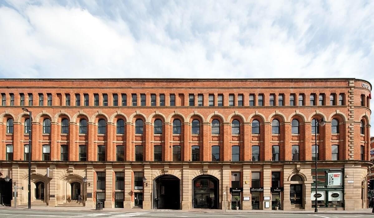 Exterior view of the historic red brick facade of Portland Buildings on Portland Street.