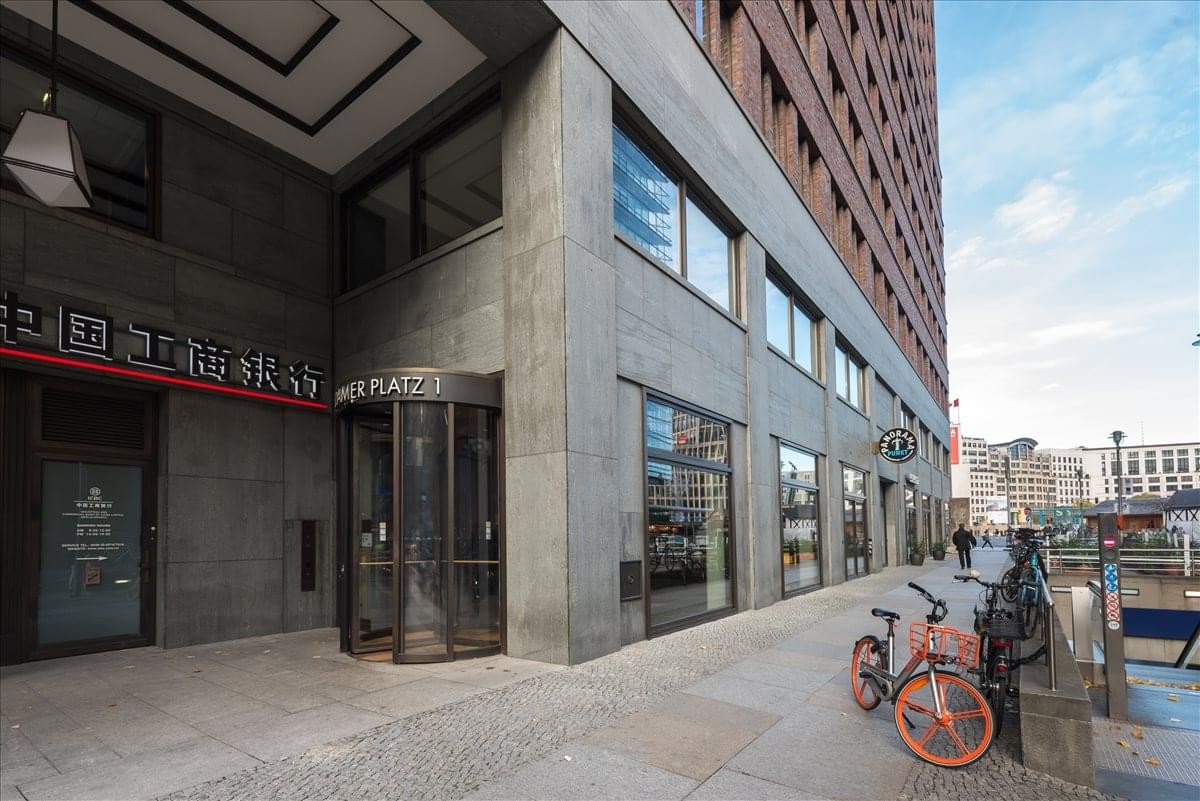 Exterior view of the modern stone and glass facade of Potsdamer Platz 1.