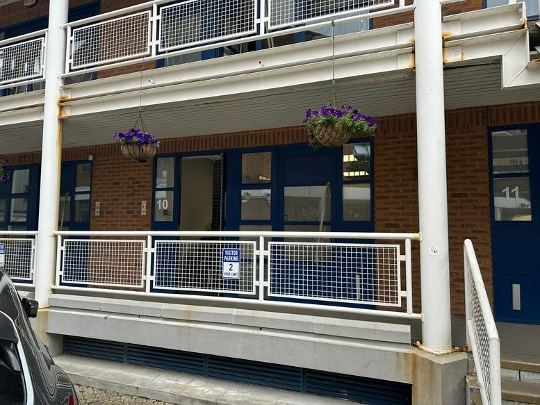 Exterior view of the brick facade and balcony at Unit 10, Ground Floor, Princeton Mews, Kingston Upon Thames.