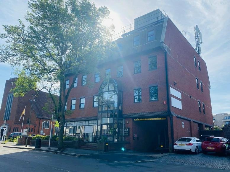 Wide exterior view of Prospect House featuring red brick facade and large tree.
