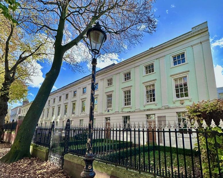 Exterior of the historic Provincial House at 37 New Walk featuring a grand light green facade.