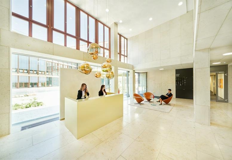 Spacious reception area with golden pendant lights at Radlkoferstraße 2, Theresienhöhe, Sendling, Munich.