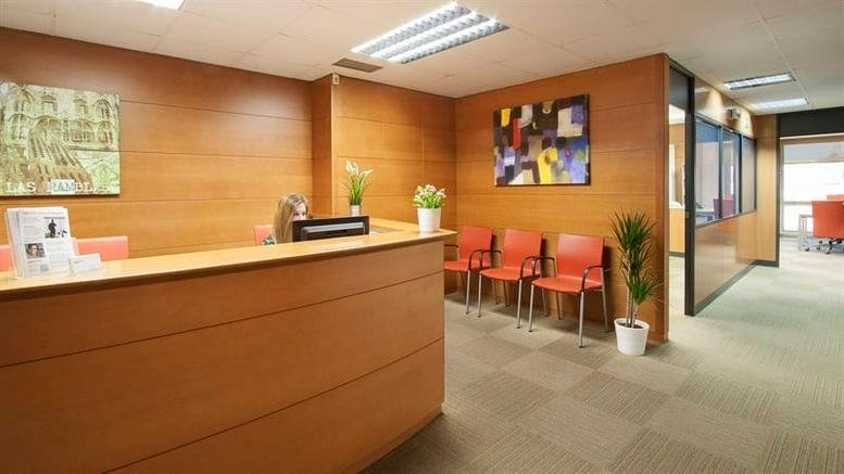 Warm, wood-paneled reception area at Rambla de Catalunya 38, 8th Floor.