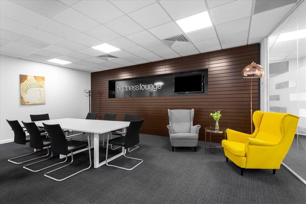 Regus House, 4 Admiral Way, Doxford International Business Park reception and breakout lounge with yellow armchair.