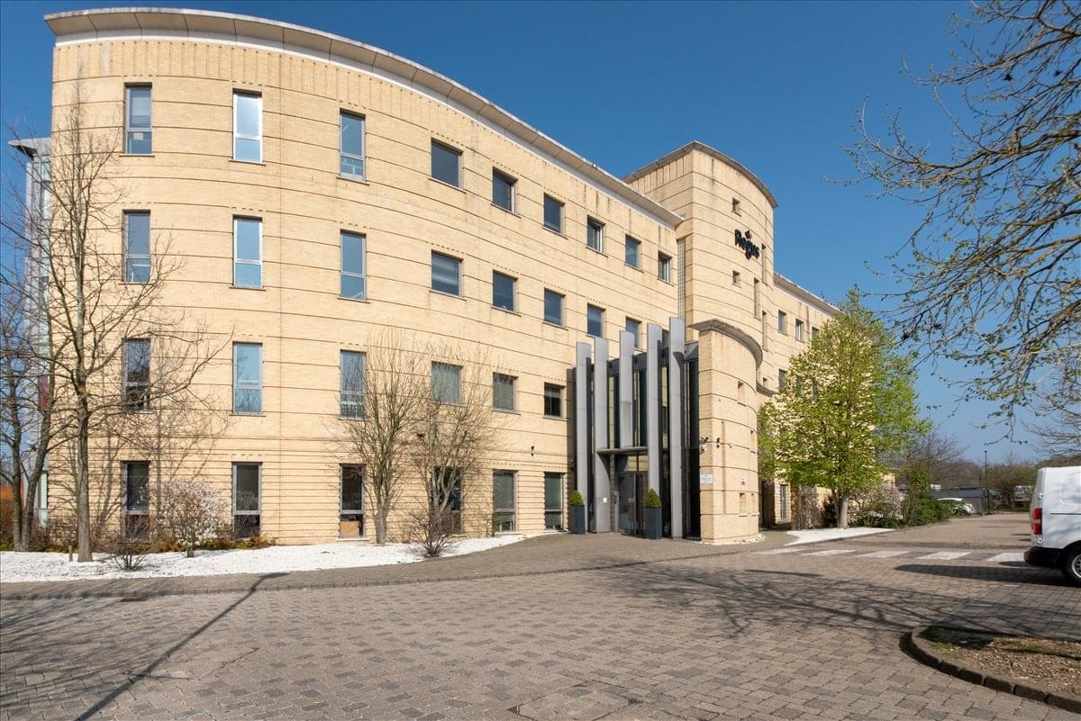 Exterior view of Regus House, 400 Thames Valley Park Drive with curved facade and blue sky.