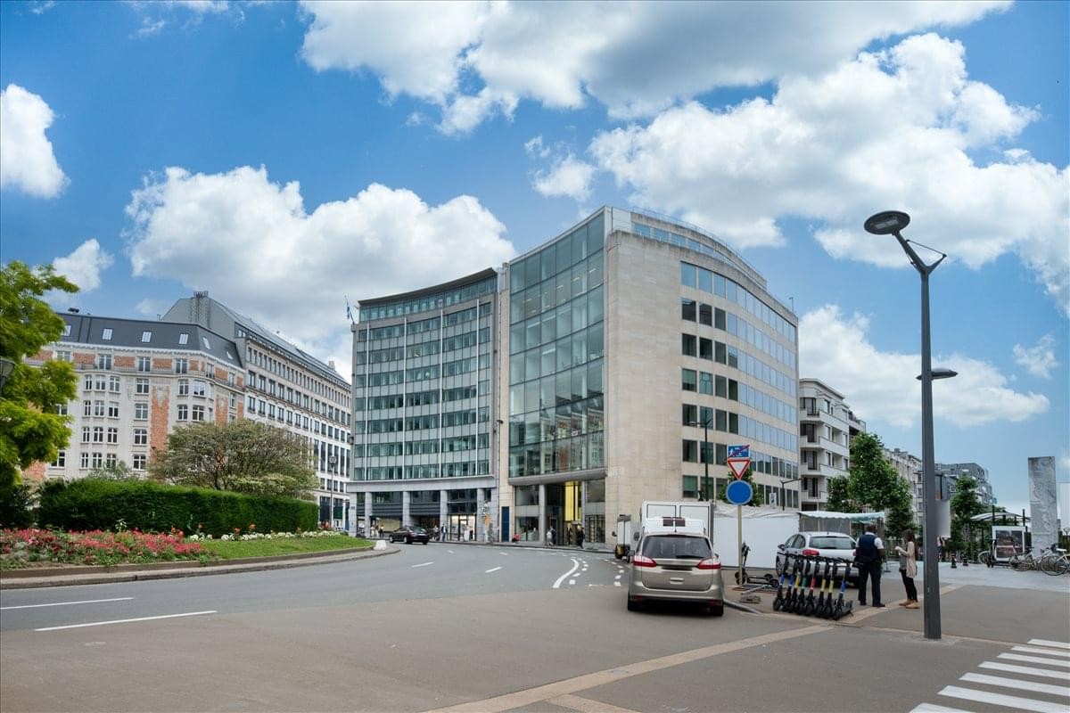 Exterior view of the modern curved glass facade at Rond Point Robert Schuman 6.