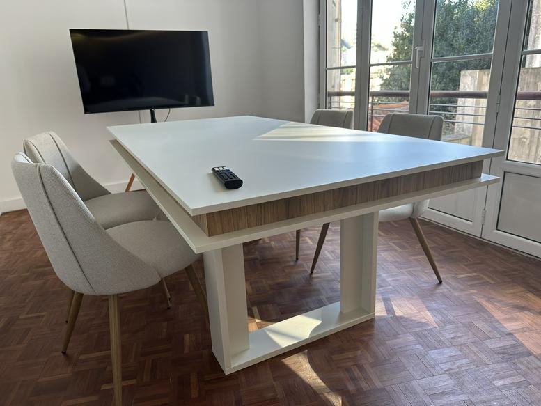 Meeting room with a white table and large TV at Santana Cowork, Rua Machado dos Santos 11 2B.