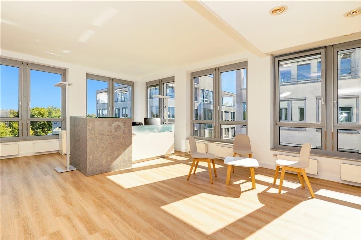 Spacious reception lobby with a stone-finish counter and multiple seating areas.