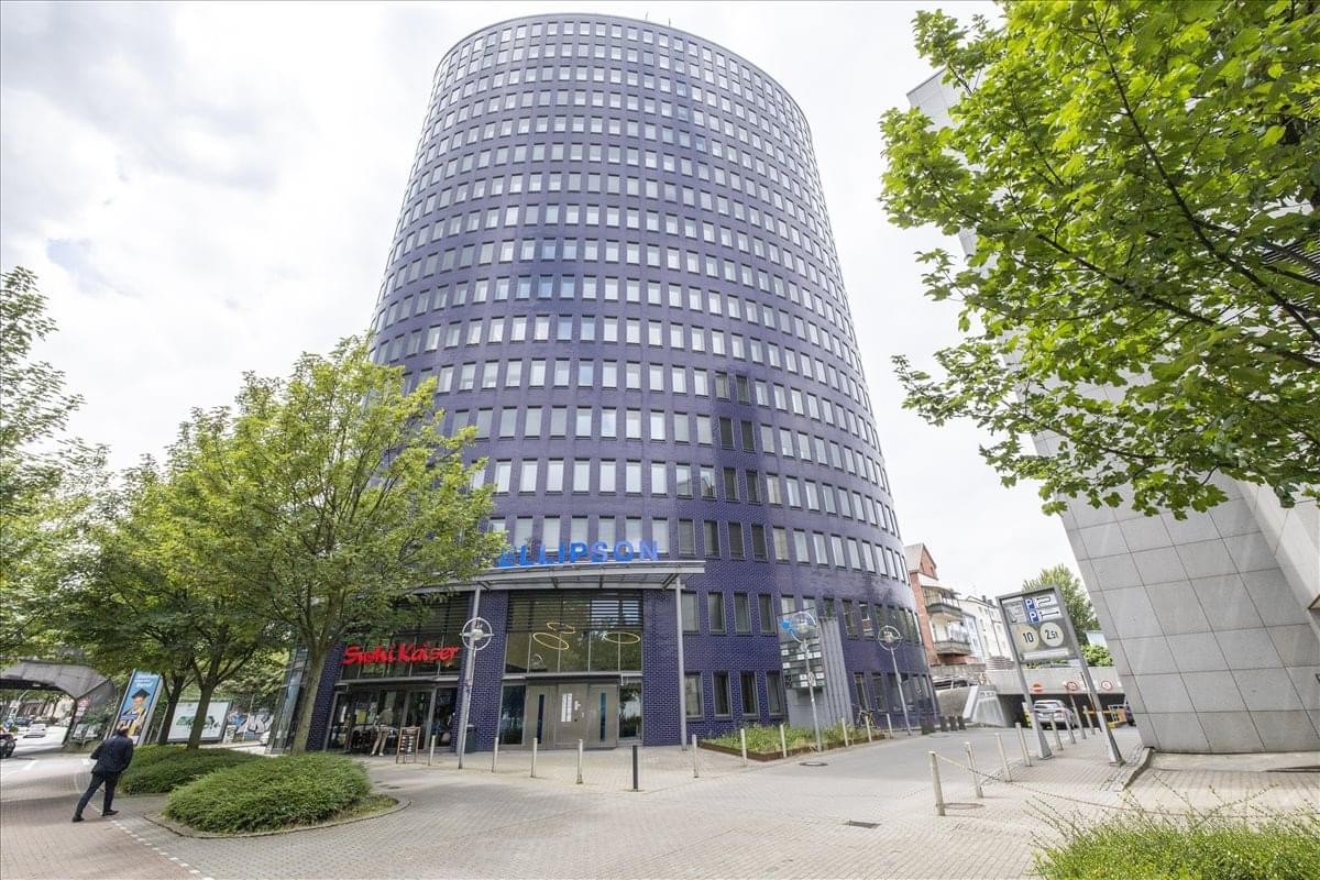 Exterior view of the iconic blue glass Ellipson building at Ruhrallee 9.