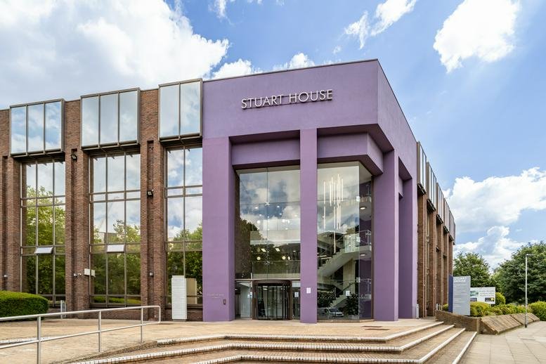 View of the purple facade and glass entrance at Stuart House.