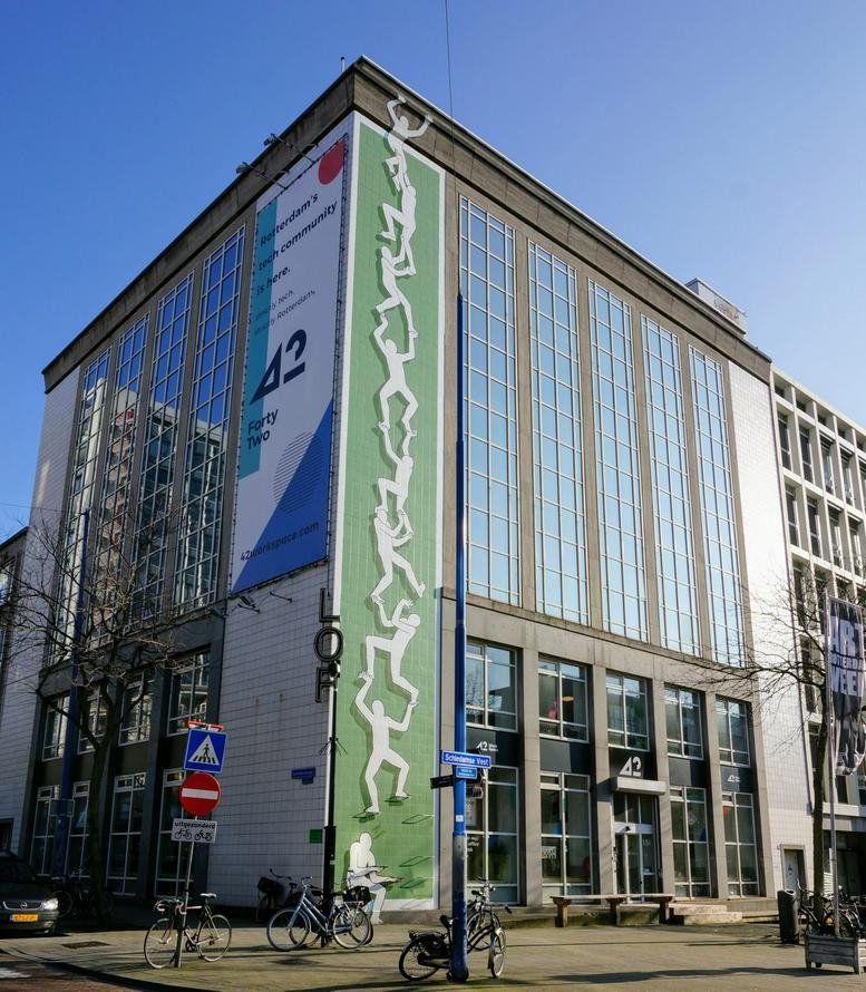 Exterior view of the office building at Schiedamse Vest 154 with a green vertical mural.