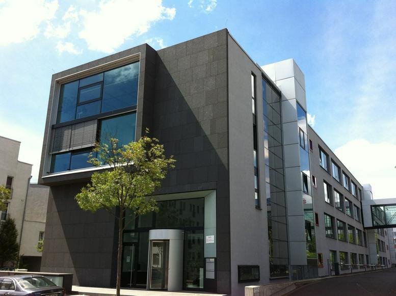 Exterior view of the modern stone and glass facade at Sebastian-Kneipp-Str. 41.