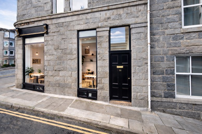 Exterior stone facade and street-level entrance of Skene House, 96 Rosemount Viaduct.