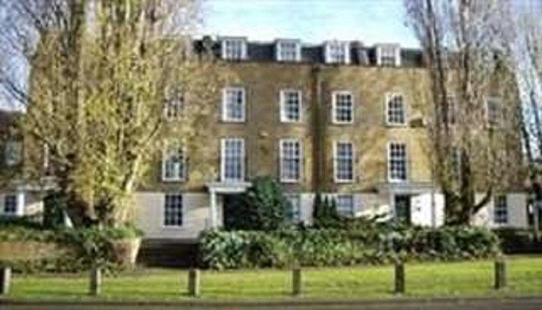 Exterior view of the historic brick facade of Solution House with large sash windows.