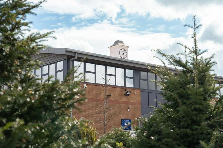 Exterior facade of St George’s Business Park with red brickwork and large upper-story windows.