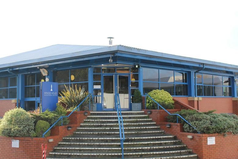 Exterior entrance of Station Road, Kings Langley, Hertfordshire with blue facade and brick steps.