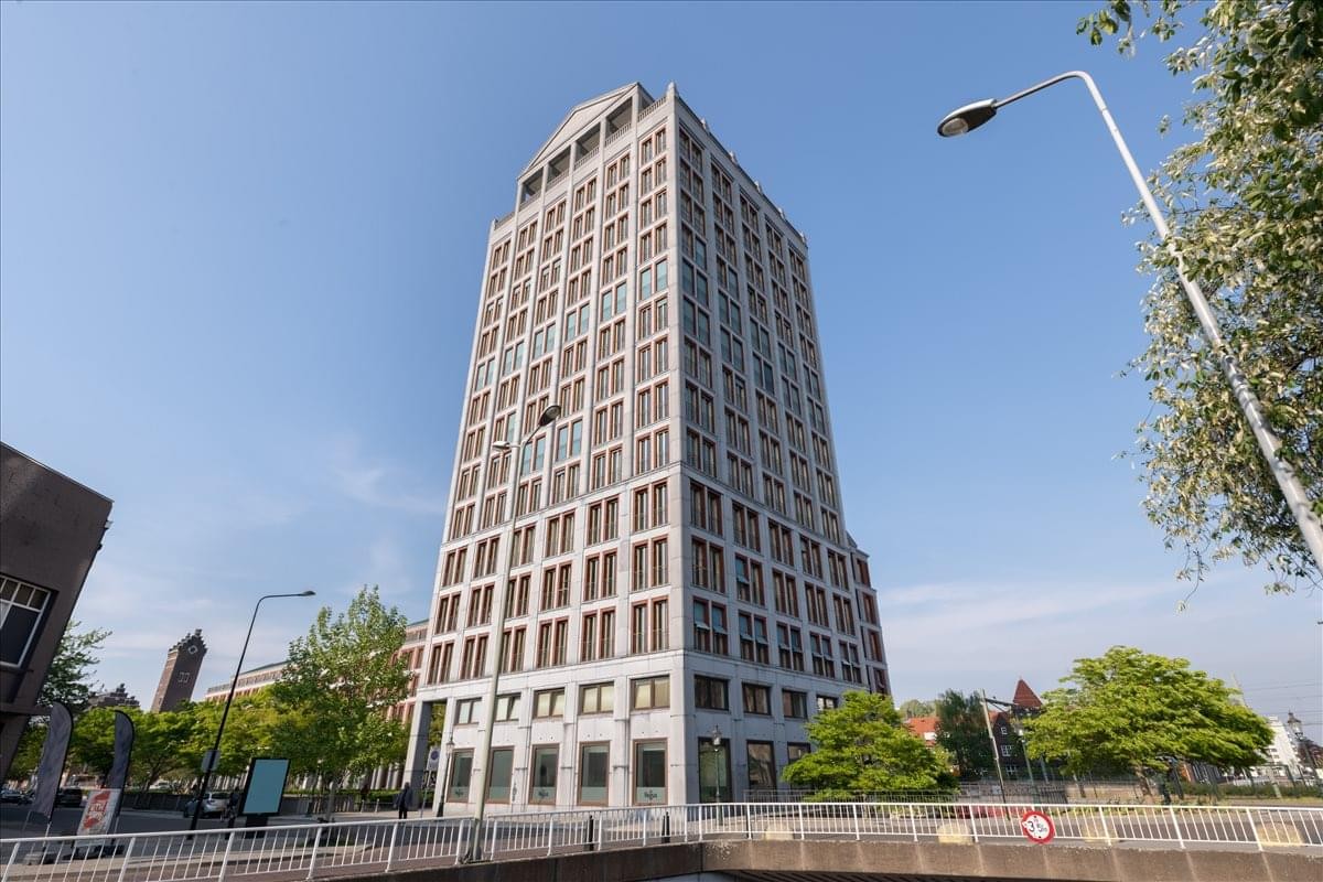 Exterior view of the historic tall brick tower building at Stationsplein 8K.