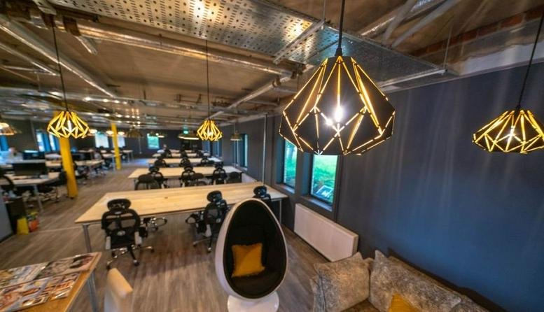 Spacious open-plan workspace at The Avenue by Haatch Desks featuring geometric pendant lights and white desks.