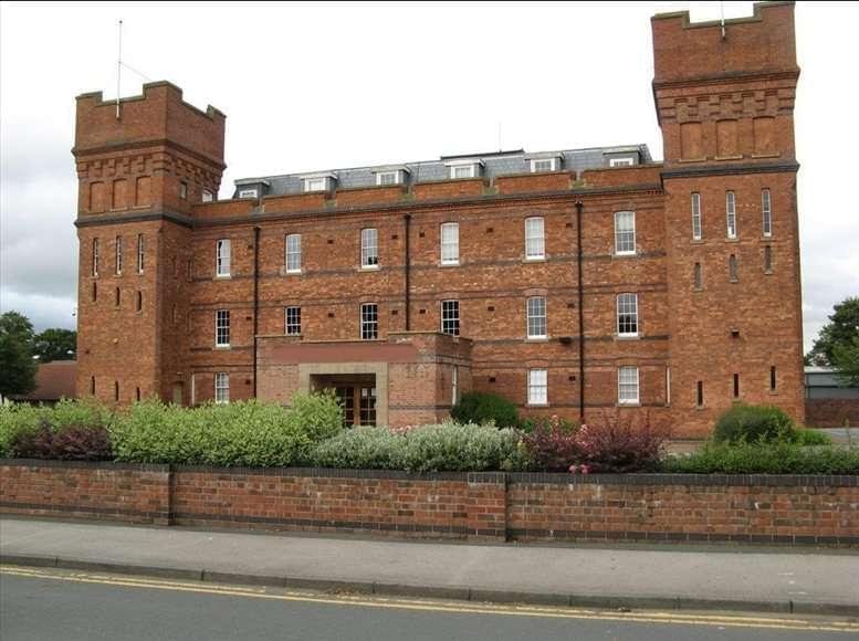 Exterior view of the historic brick facade and towers of The Barracks Business Centre.