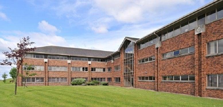 Exterior view of The Beehive, Lions Drive, showing the brick building and green lawn.