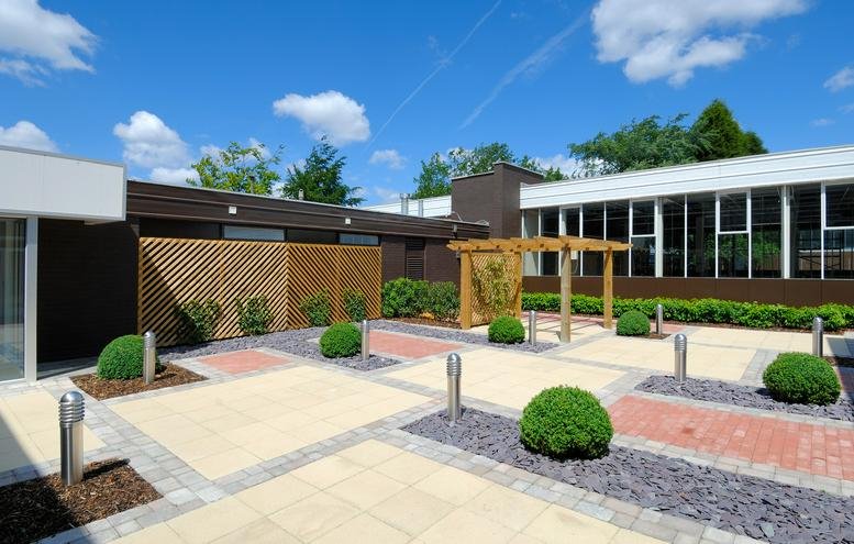 Exterior view of the landscaped courtyard and modern facade at The Courtyard, Stanley Green Business Park.