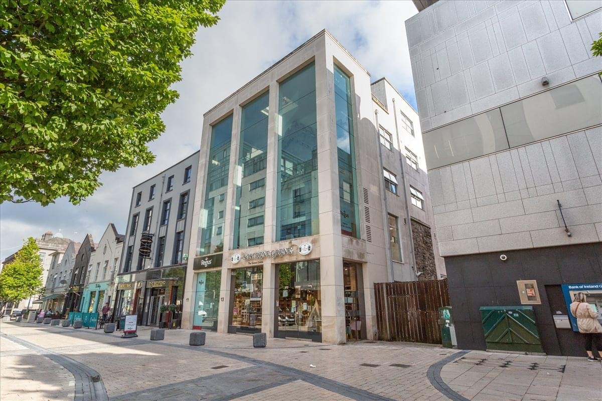 Exterior view of the modern glass and stone facade of The Gallery, The Old Savoy Complex.