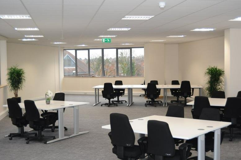 Spacious open-plan office at The Landmark, Tudor Square featuring multiple white desks and black chairs.
