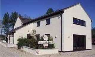 Exterior view of the white-walled building at The Stables, Rooksbridge, Somerset.