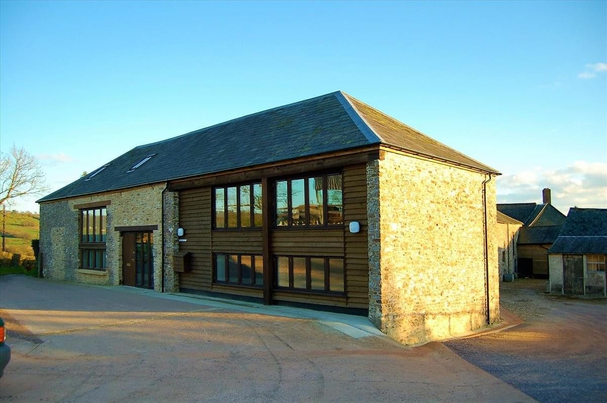 Exterior view of the stone and timber facade at The Threshing Barn and the Stable Yard offices.