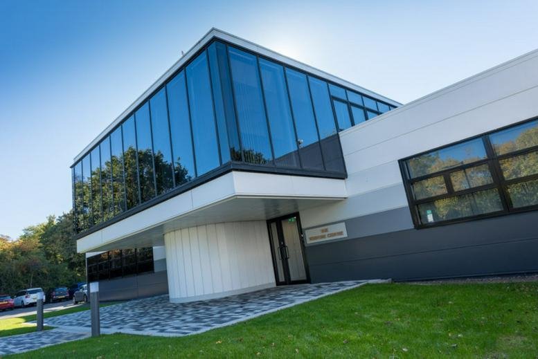 Exterior view of the modern glass-facade Venture Centre with white architectural accents.