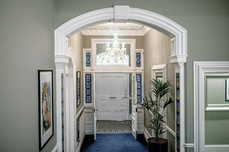 Grand arched entryway of The Victorians, 15, 18 Earlsfort Terrace leading to a bright hallway.