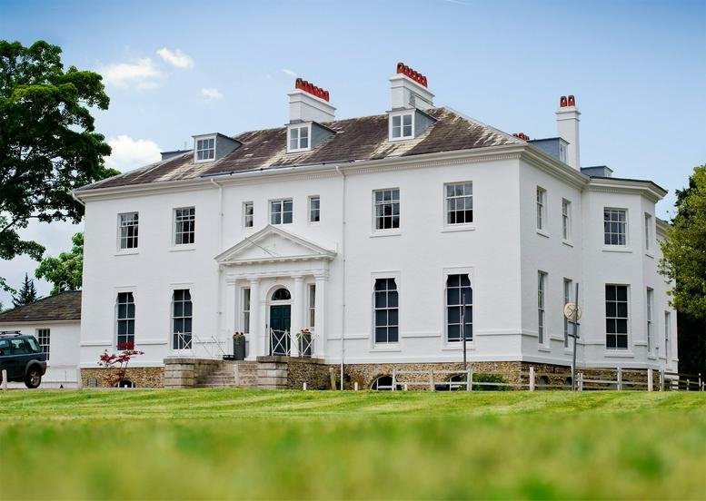 Exterior view of the white Georgian facade at Thorncroft Manor.