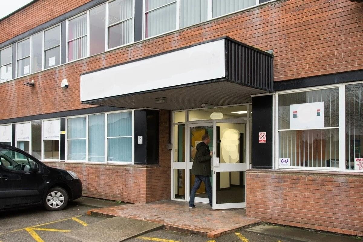 Exterior entrance of Thornes Mill, Denby Dale Road, featuring a brick facade and black awning.