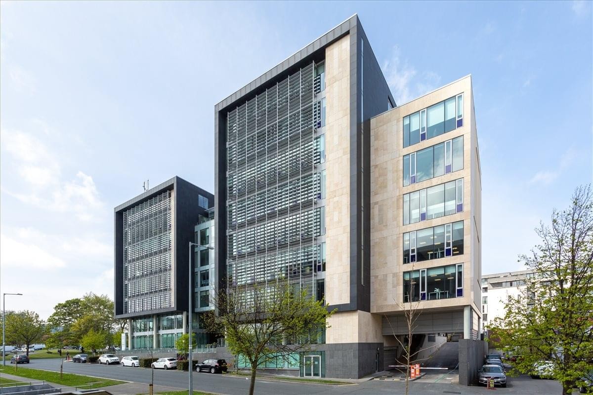 Exterior view of the contemporary glass and stone facade at The Chase, Carmanhall Road, Dublin 18.