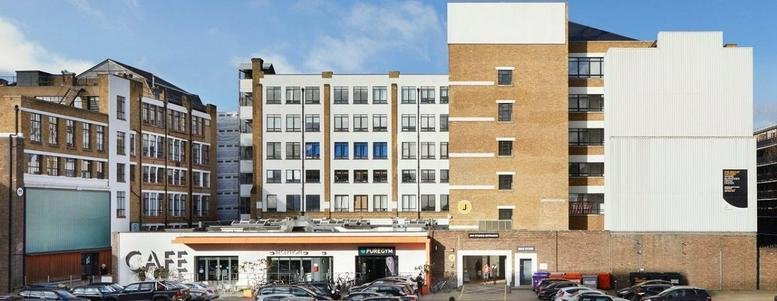 Exterior view of the multi-storey industrial style brick facade at Peek House, The Biscuit Factory.