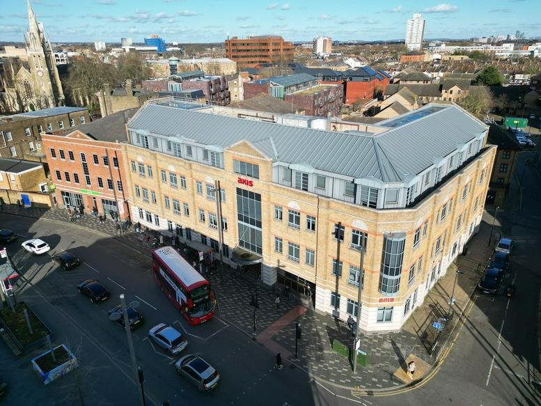 Exterior view of the brick facade at 3 Tramway Avenue under a clear blue sky.