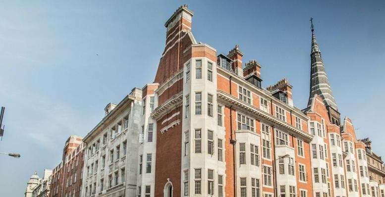 Exterior view of the red brick and stone facade of Twelve Audley House, 12-12a Margaret Street.