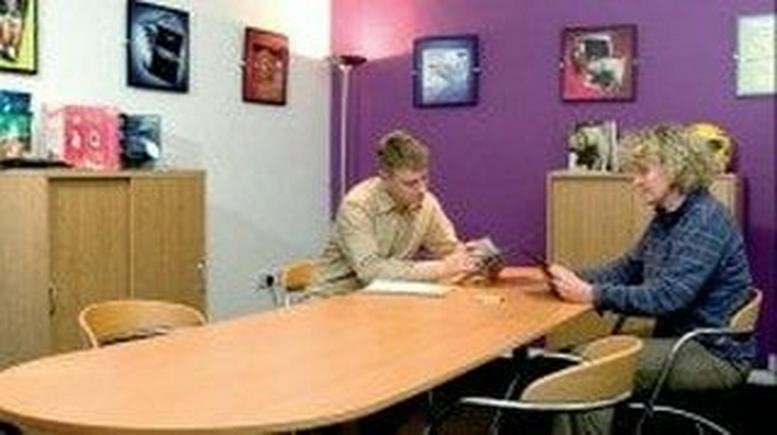 Team meeting at Unit K70, Chapel Place, Abington Square, Northampton with a purple feature wall.