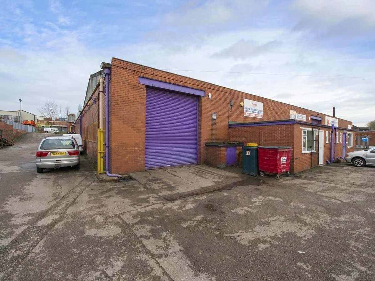 Exterior brick facade of Units 7 and 15, Longport Enterprise Centre with a purple loading bay door.