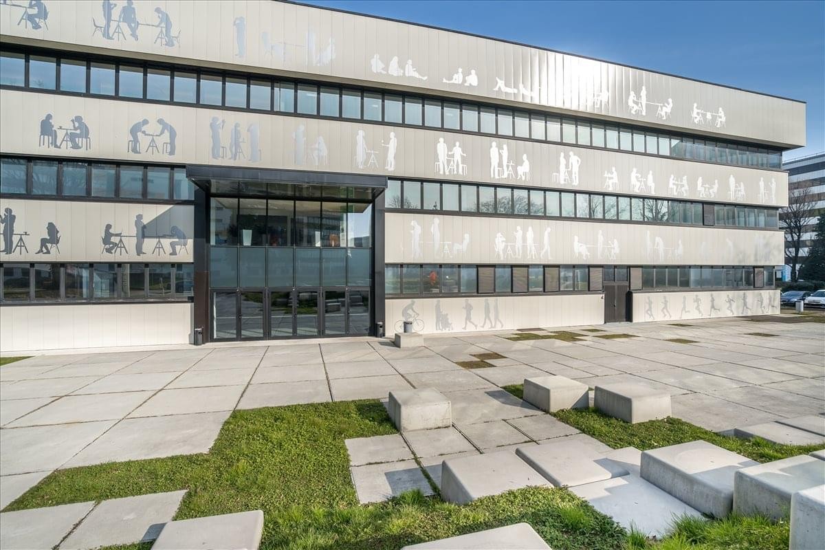 Exterior view of the modern glass and concrete facade at Via Caldera, 21, Building F, Piano 1.