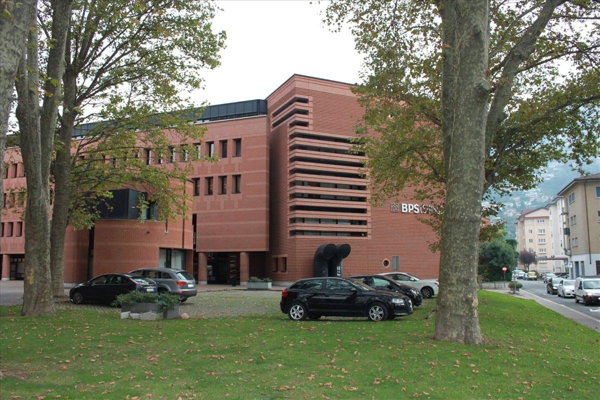 Exterior view of the red brick building at Via Maggio 1, 6900.