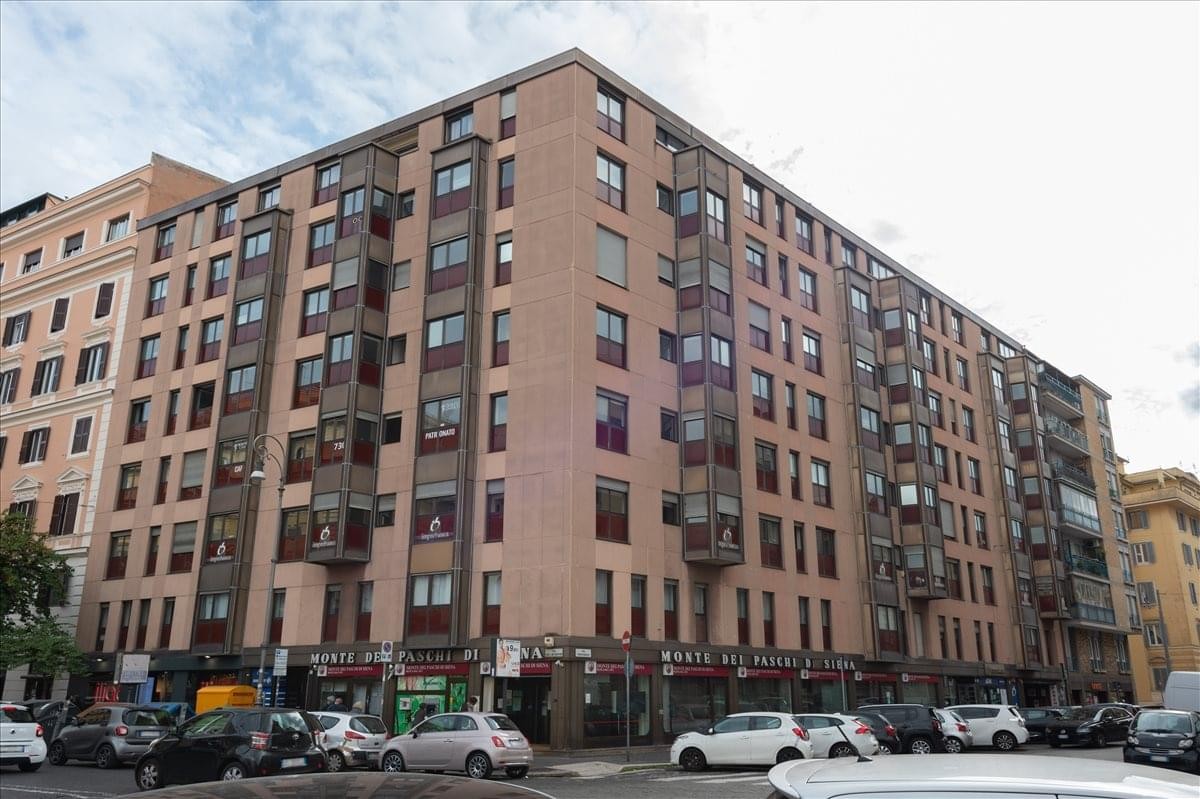 Exterior view of the multi-story brick building at Via Properzio, 5, 4th floor, Prati, Rome, Italy.