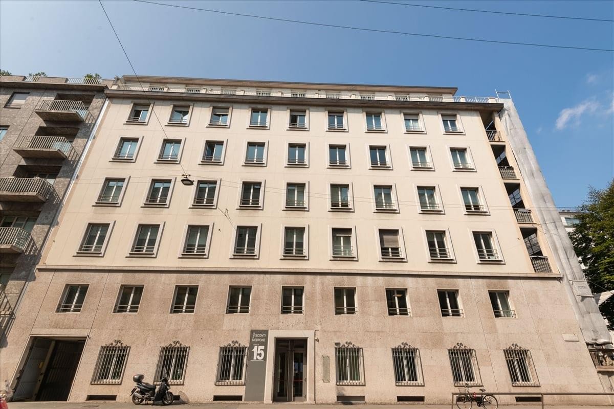 Exterior facade of the stone building at Via Uberto Visconti di Modrone 15.