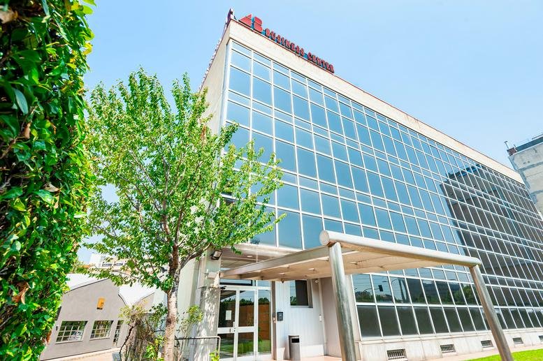 Exterior view of the glass-facade building at Via Valla 16, Southern Milan.