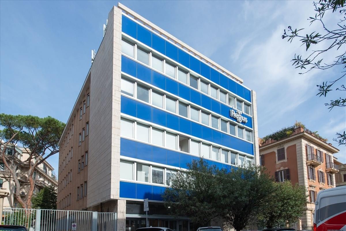 Exterior facade of the blue and white building at Via Vincenzo Bellini 22, Parioli.