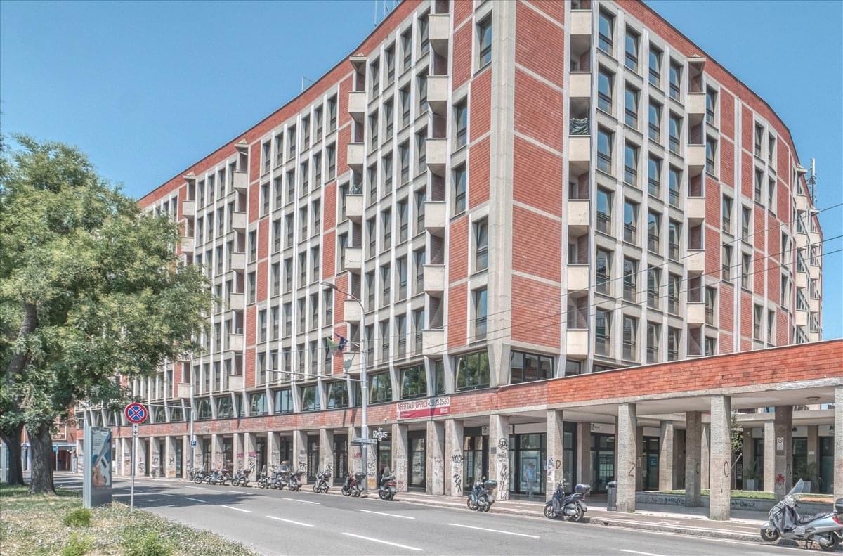 Exterior view of the multi-story brick building at Viale Angelo Masini 12-14, Bologna.