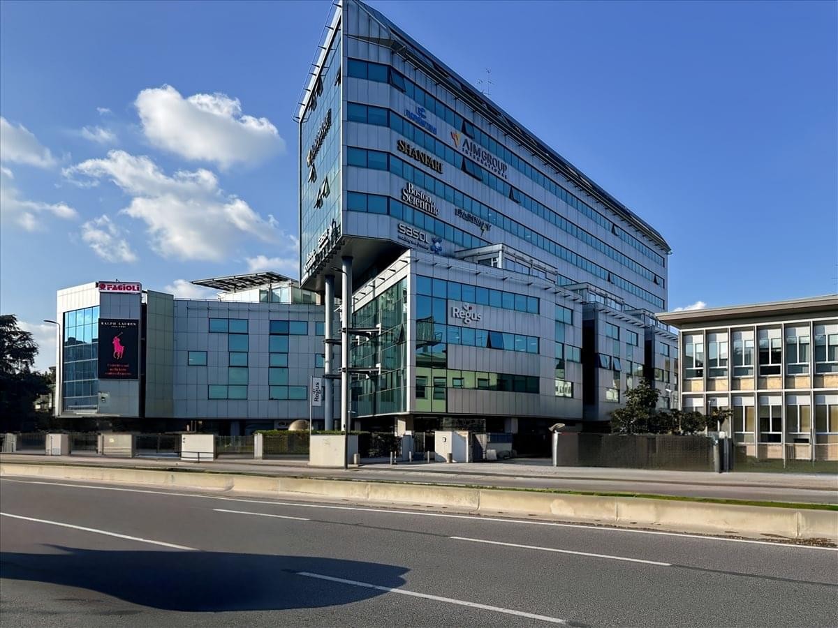 Exterior view of the contemporary glass and steel building at Viale Enrico Forlanini 23.