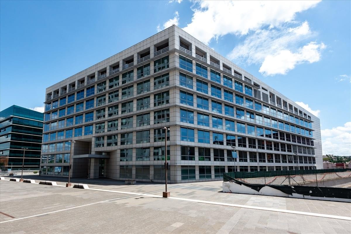 Exterior view of the modern glass-facade building at Viale Giorgio Ribotta 11.