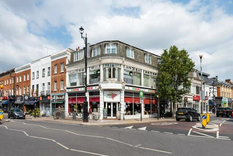 Exterior view of Victory House, 46 Victoria Road, a corner building featuring a cafe and retail units.