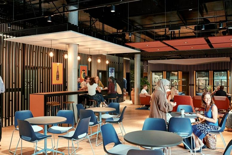 Spacious communal lounge and cafe area with various seating options at Vox Studios, 1-45 Durham Street.